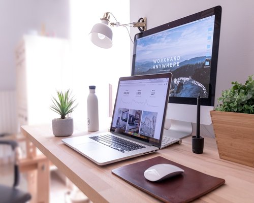 A clean desk setup showing a comfortable distance between a laptop screen and the user